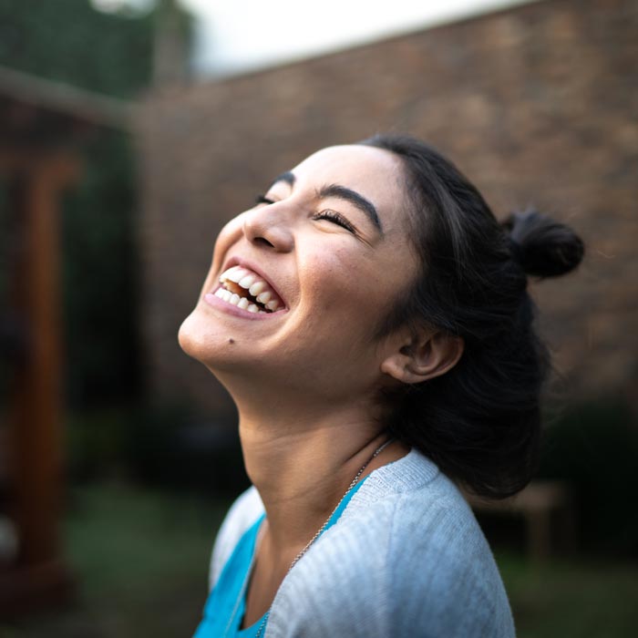 happy woman smiling and enjoying being outdoors