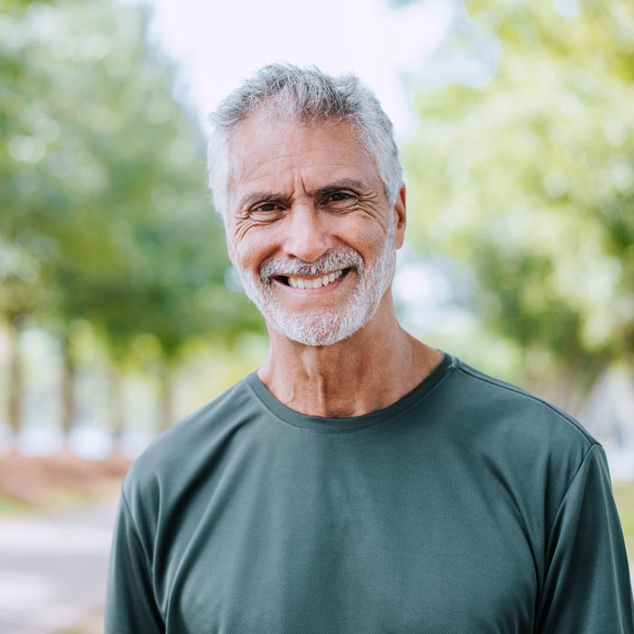 Portrait of a senior man on a workout in the public park