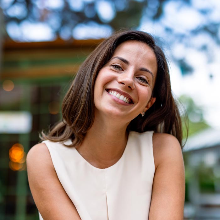 Smiling woman enjoying her time at outdoor cafe