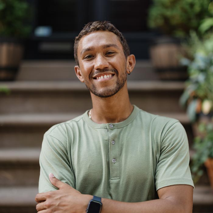 Happy Young Man Smiling Outdoors on a Bright Day