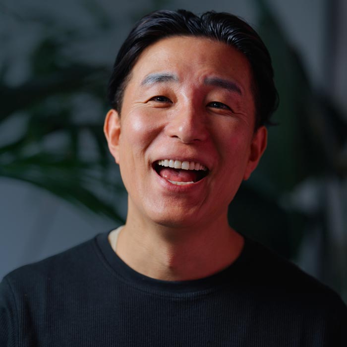 portrait of Japanese man looking at camera and laughing